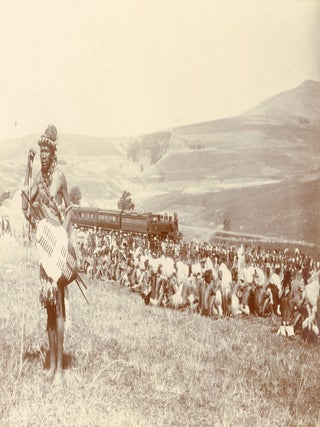 Item #1574 ZULU CEREMONIAL GATHERING WITH TRAIN IN BACKGROUND, NATAL, SOUTH AFRICA &mdash; ca....