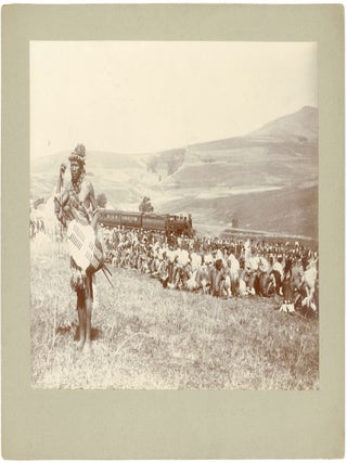 ZULU CEREMONIAL GATHERING WITH TRAIN IN BACKGROUND, NATAL, SOUTH AFRICA &mdash; ca. 1895&ndash;1905